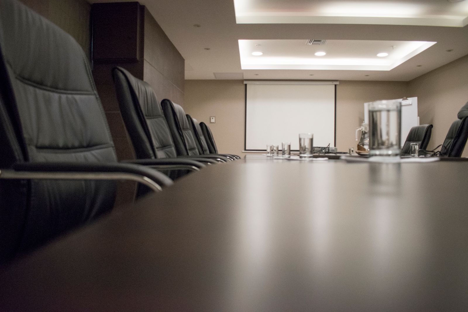 Empty executive boardroom with a polished conference table