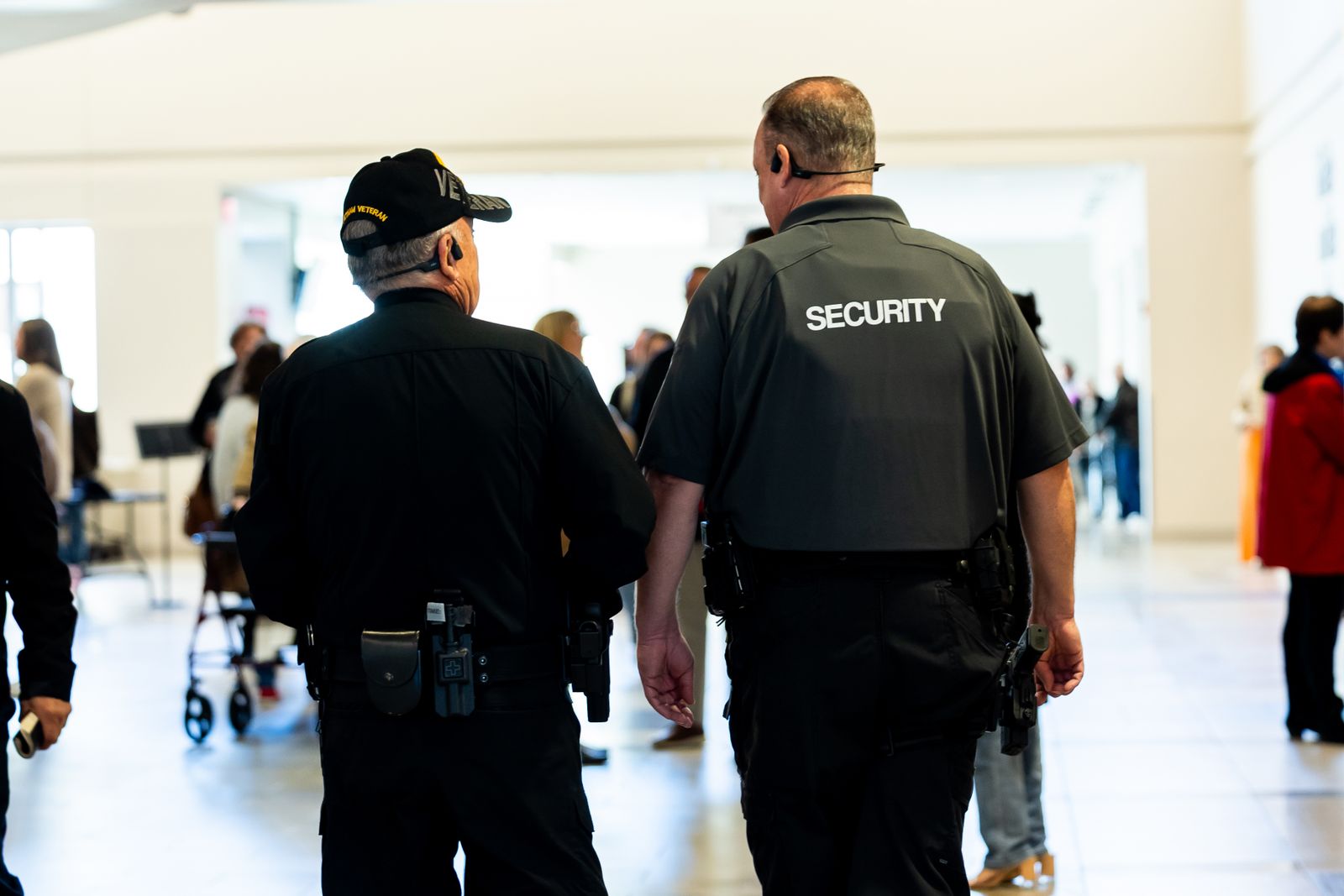 Security personnel monitoring a busy venue concourse