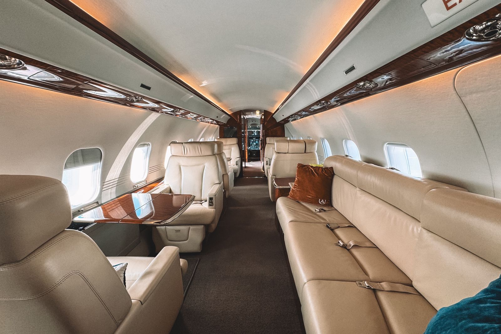 Cabin interior of a private jet with cream leather seating