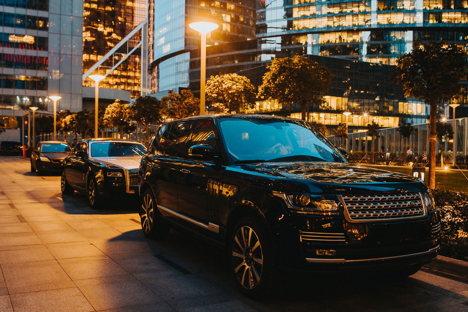 Black luxury SUV moving through a city at night